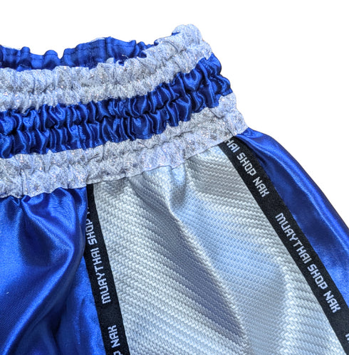 ムエタイショップNAKオリジナルのオーダーキックパンツ(ショート丈)ブルーxシルバー、刺繍カスタム対応