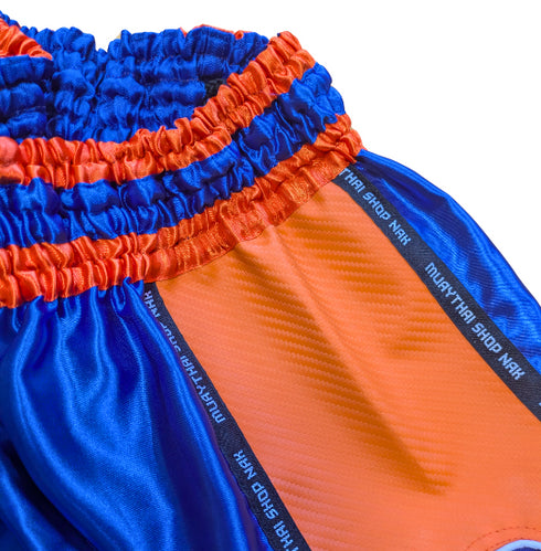 ムエタイショップNAKオリジナルのオーダーキックパンツ(ショート丈)ブルーxオレンジ、刺繍カスタム対応
