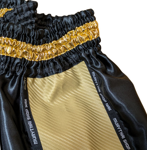 ムエタイショップNAKオリジナルのオーダーキックパンツ(ショート丈)ブラックxゴールド、刺繍カスタム対応